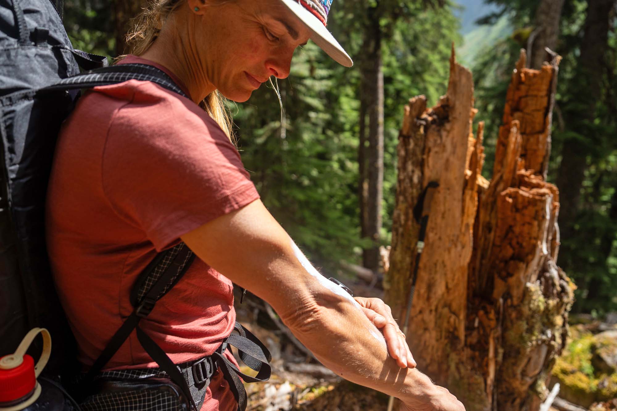 Applying sunscreen with short-sleeve hiking shirt